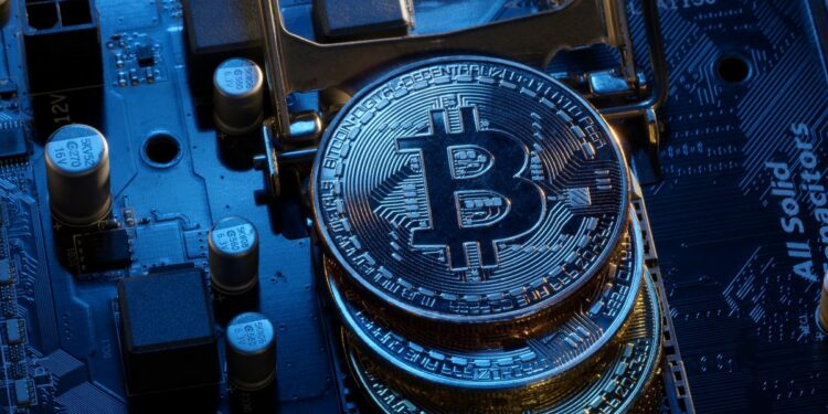 Monedas de Bitcoin sobre una tarjeta de computadora