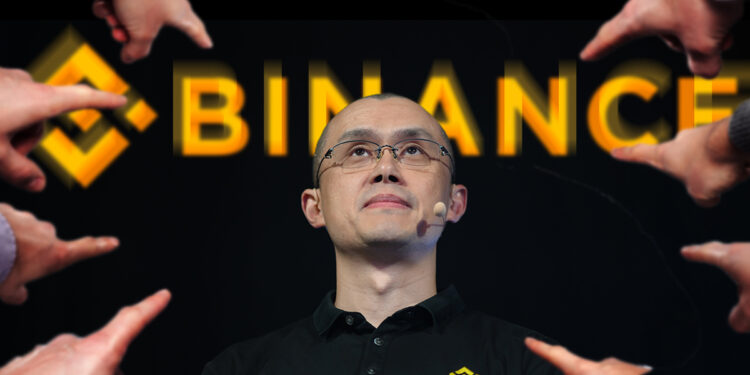 manos señalando a Changpeng Zhao, CEO de Binance con logo de la empresa detrás